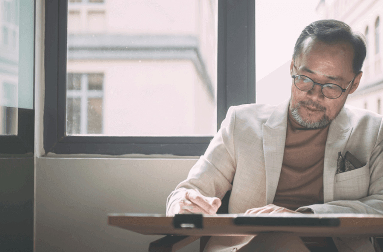 Ed Mun, Founder of SUA Interior Design, working at his desk