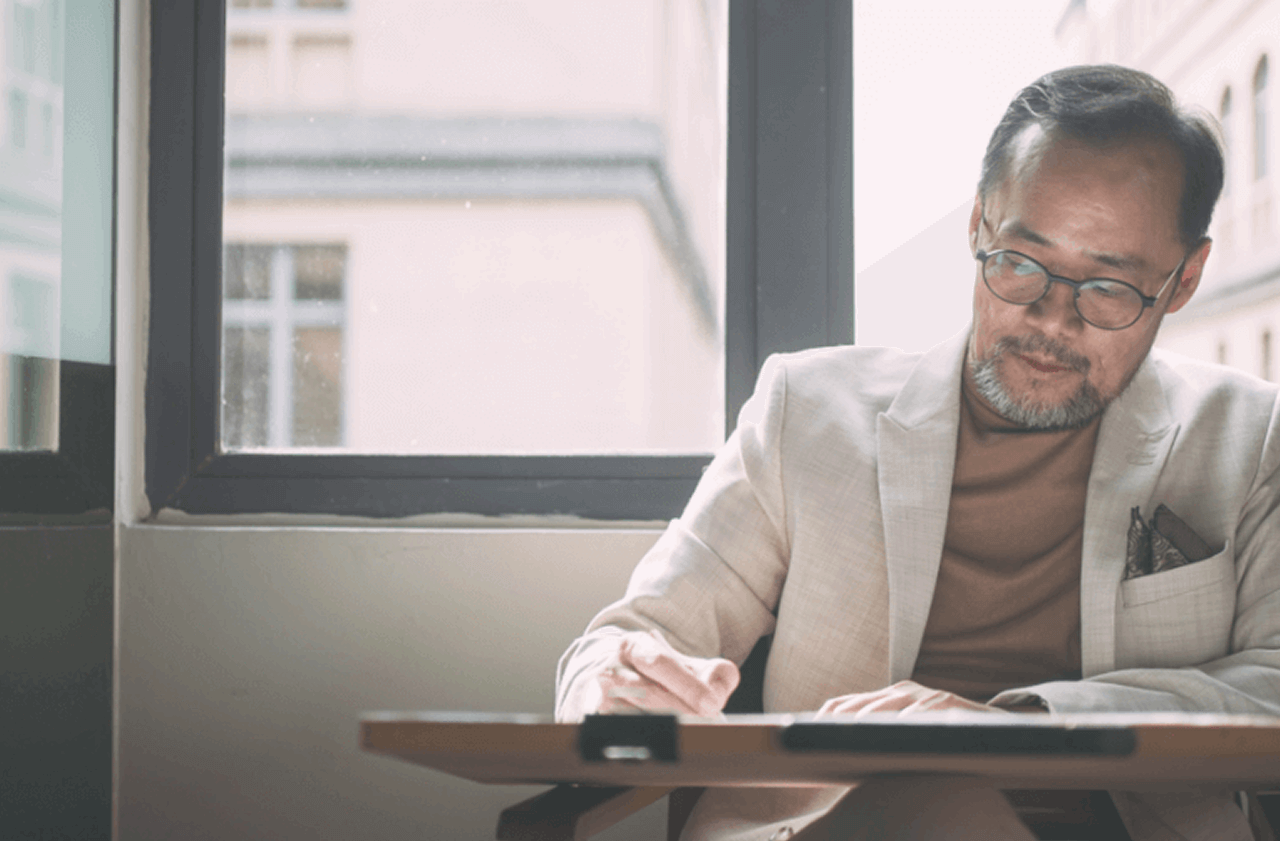 Ed Mun, Founder of SUA Interior Design, working at his desk